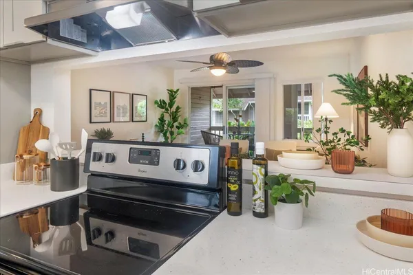 a kitchen with a stove and a white cabinets