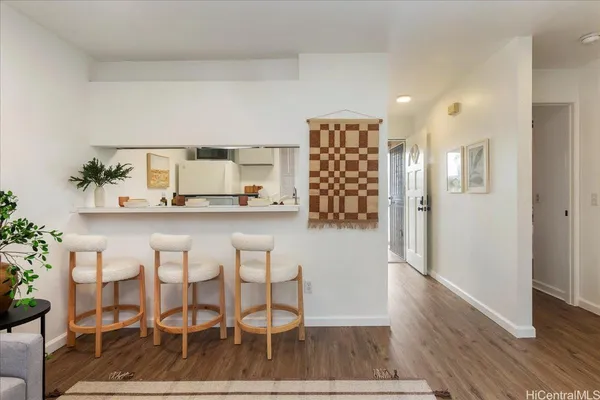 a dining room with furniture and wooden floor