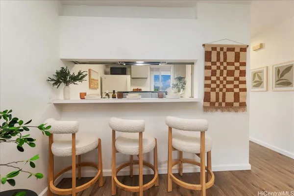 a dining room with furniture and wooden floor