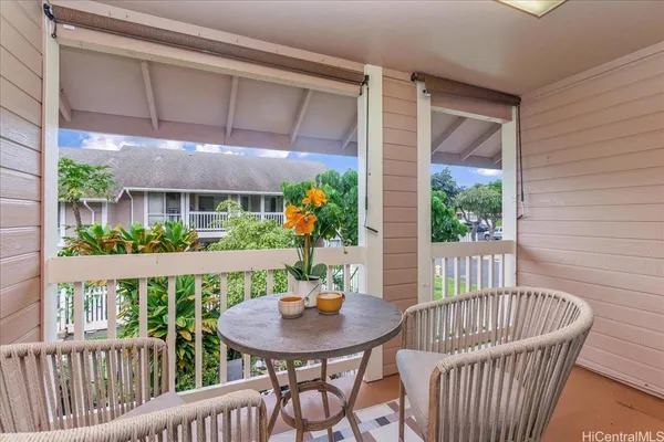 a view of a balcony with furniture