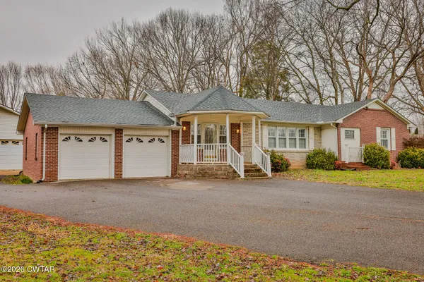 a view of a house with a patio and a yard