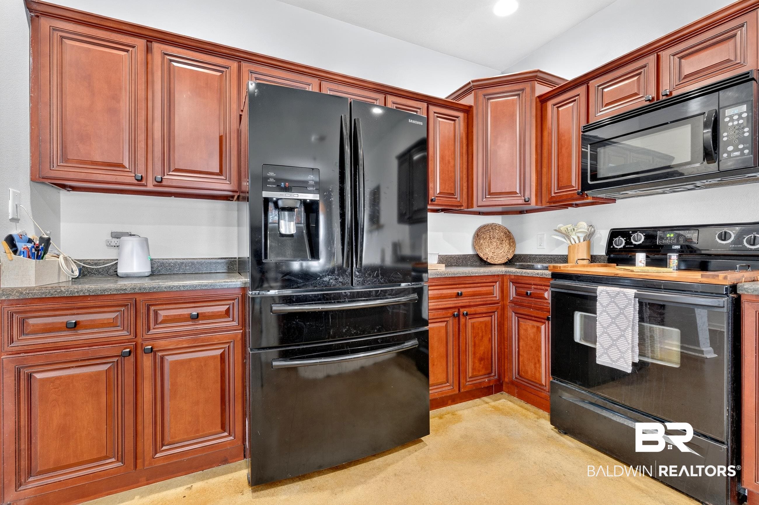 17419 Lewis Smith Drive Foley, AL 36535 - Photo 14 of 38 Kitchen featuring wood cabinetry, dark countertops, a black French door refrigerator, a black electric range, and an over-the-range microwave