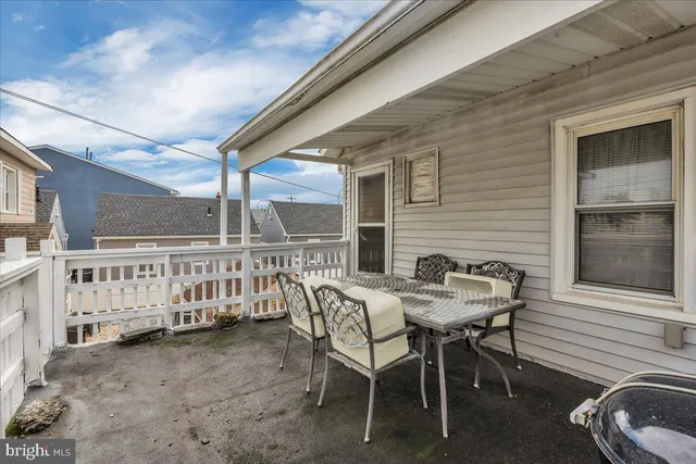 a balcony with table and chairs
