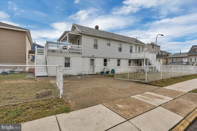 a view of a white house with a yard