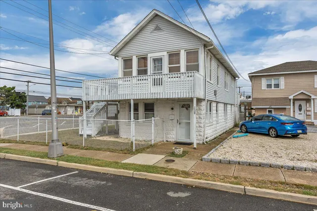a front view of a house with a wooden fence
