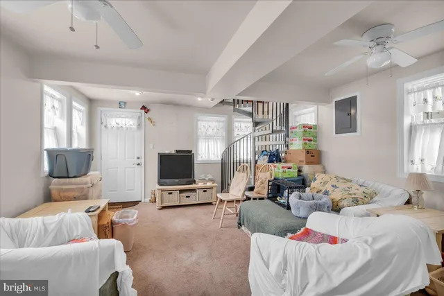 a living room with furniture a window and a flat screen tv