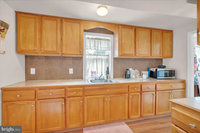 a kitchen with granite countertop cabinets and window