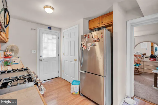 a view of kitchen with furniture and a refrigerator