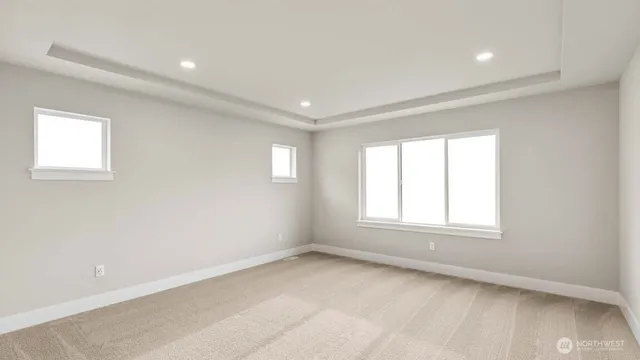 an empty room with a window and a kitchen