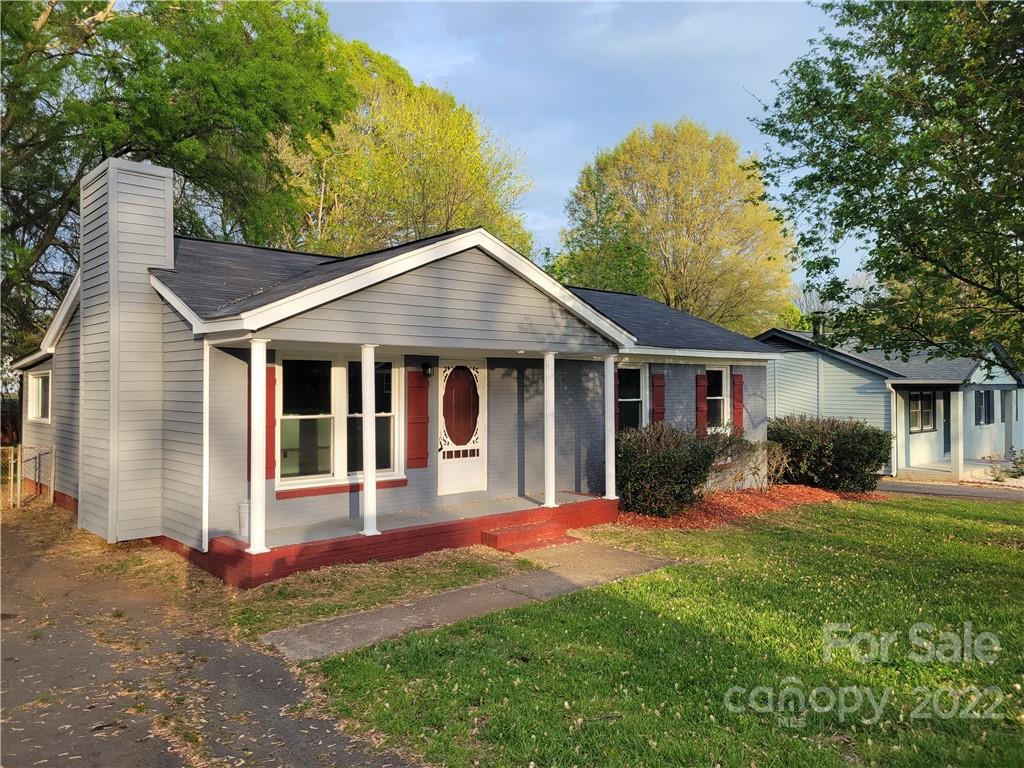 a front view of a house with a yard and porch