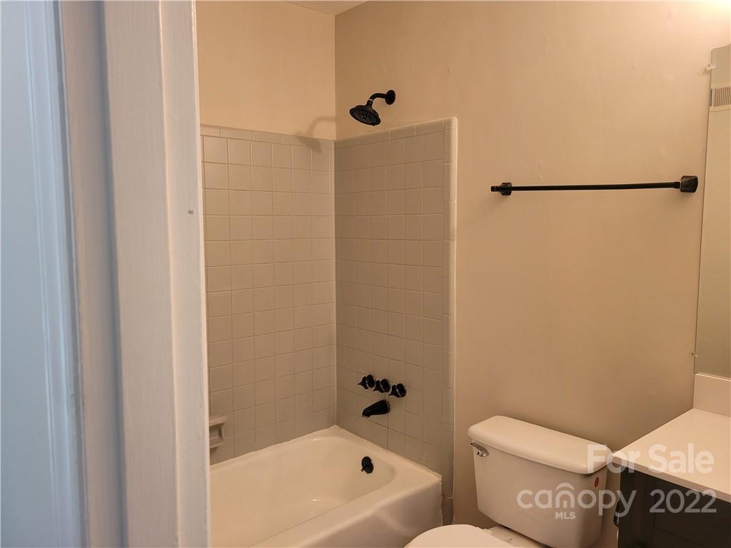943 Tilden Road Charlotte, NC 28214 - Photo 13 of 14 a bathroom with a toilet and a bath tub