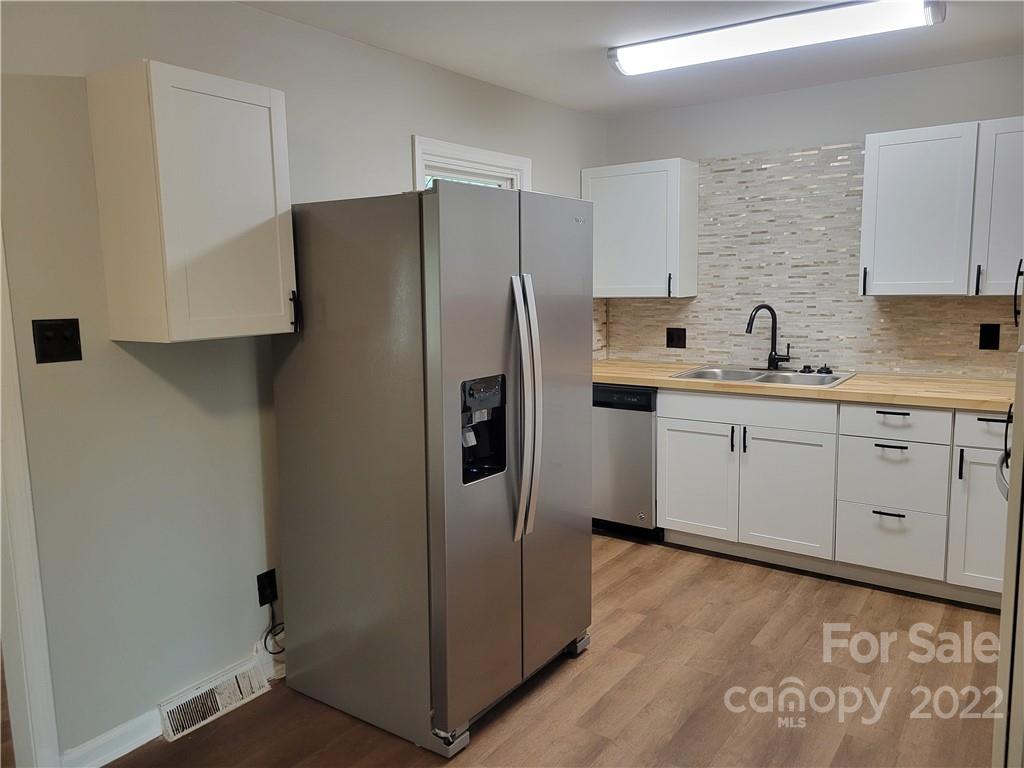 943 Tilden Road Charlotte, NC 28214 - Photo 4 of 14 a kitchen with stainless steel appliances a refrigerator sink and cabinets