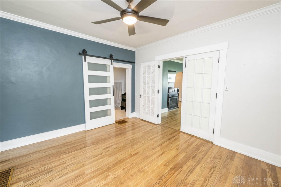 190 Swailes Road Troy, OH 45373 - Photo 17 of 82 This inviting space features elegant hardwood flooring and classic crown molding, perfect for comfortable living.