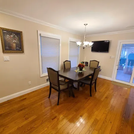 a dining room with furniture and wooden floor
