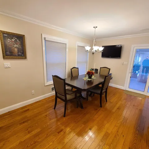 a dining room with furniture and wooden floor