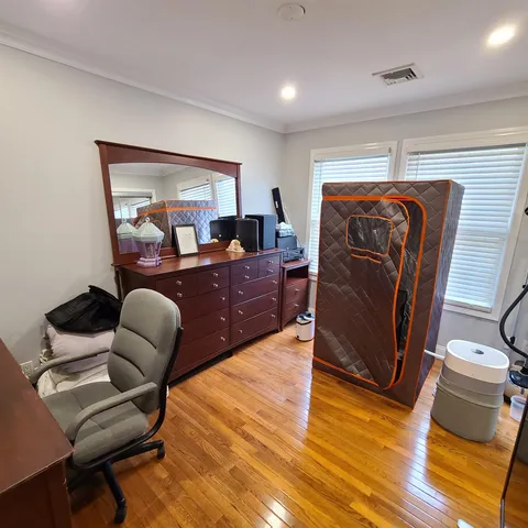 a bed room with furniture and wooden floor