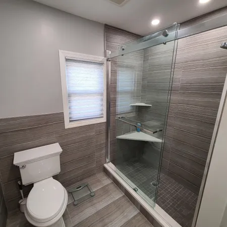 a bathroom with a toilet and a shower