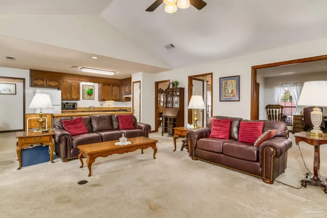 a view of a workspace with bookshelf and a window