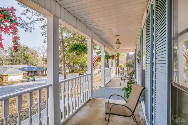 a view of a porch with furniture and garden
