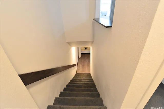 a view of a hallway with wooden floor and entryway