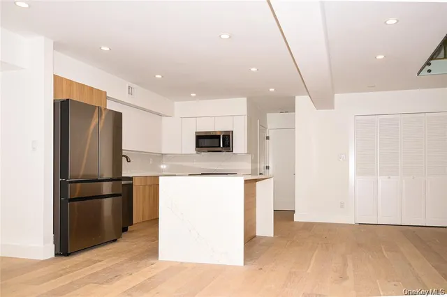 a kitchen with stainless steel appliances a refrigerator and a stove top oven