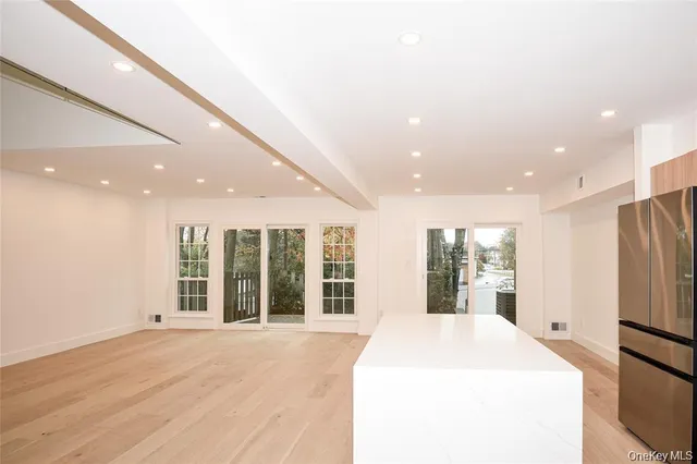 a large white kitchen with large windows