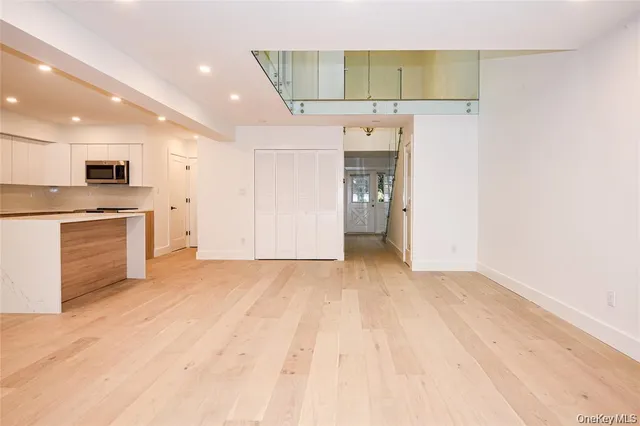 a view of a kitchen with a sink and a refrigerator
