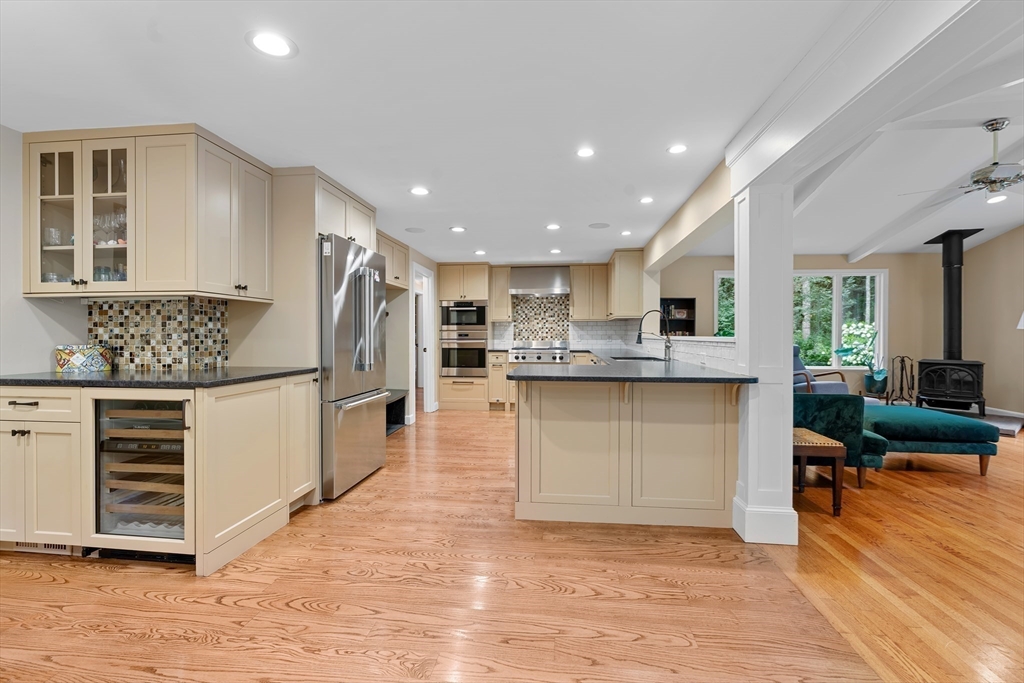50 3 Ponds Road Wayland, MA 01778 - Photo 11 of 32 a kitchen with stainless steel appliances granite countertop a refrigerator sink and cabinets