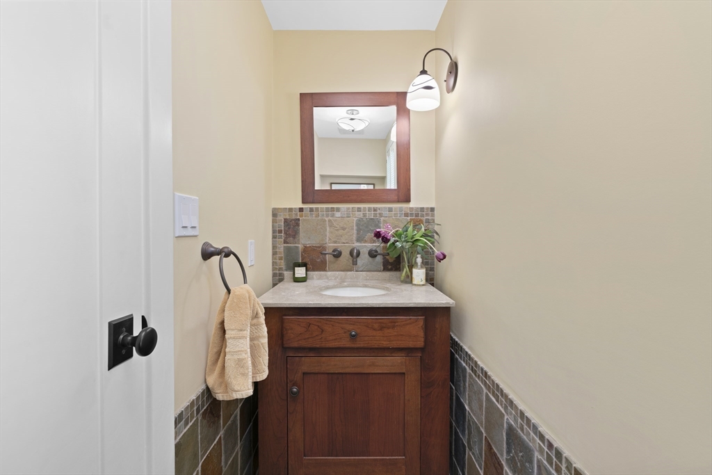 50 3 Ponds Road Wayland, MA 01778 - Photo 12 of 32 a bathroom with a sink a mirror and a window