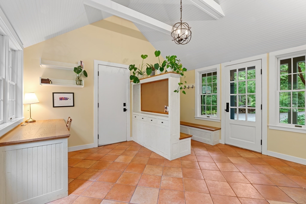 50 3 Ponds Road Wayland, MA 01778 - Photo 15 of 32 a view of a kitchen with a sink cabinet and a living room
