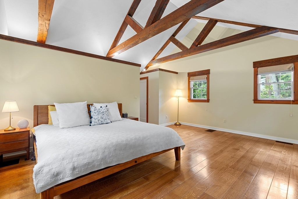 50 3 Ponds Road Wayland, MA 01778 - Photo 17 of 32 a bedroom with a bed and wooden floor