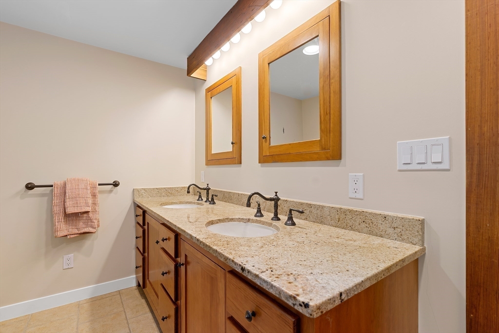 50 3 Ponds Road Wayland, MA 01778 - Photo 20 of 32 a bathroom with a granite countertop sink and a mirror