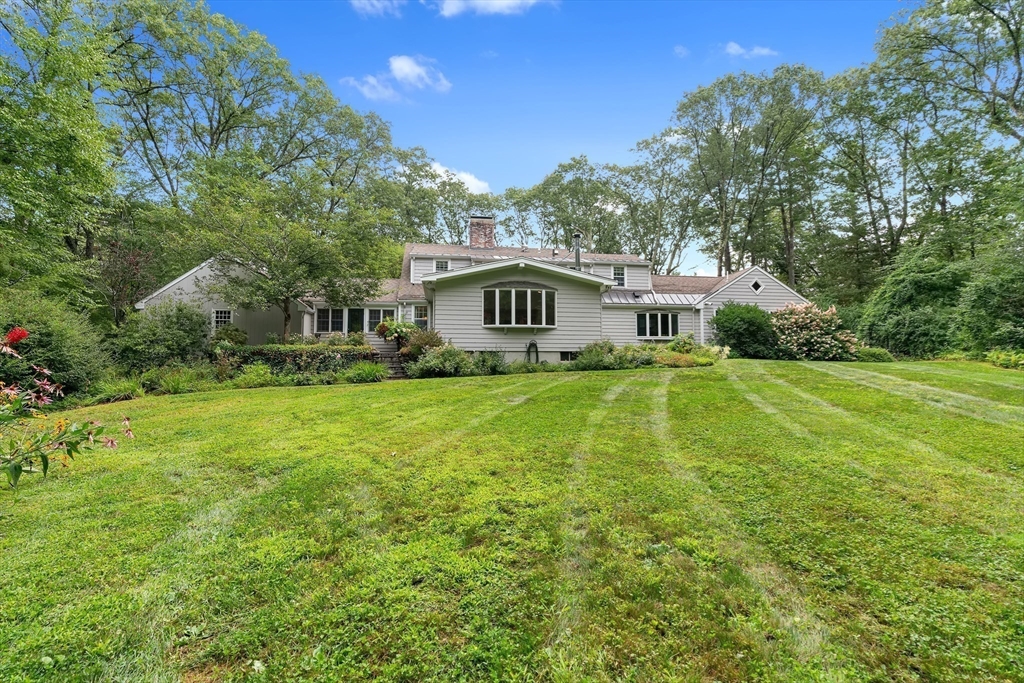 50 3 Ponds Road Wayland, MA 01778 - Photo 2 of 32 a house view with swimming pool and garden space