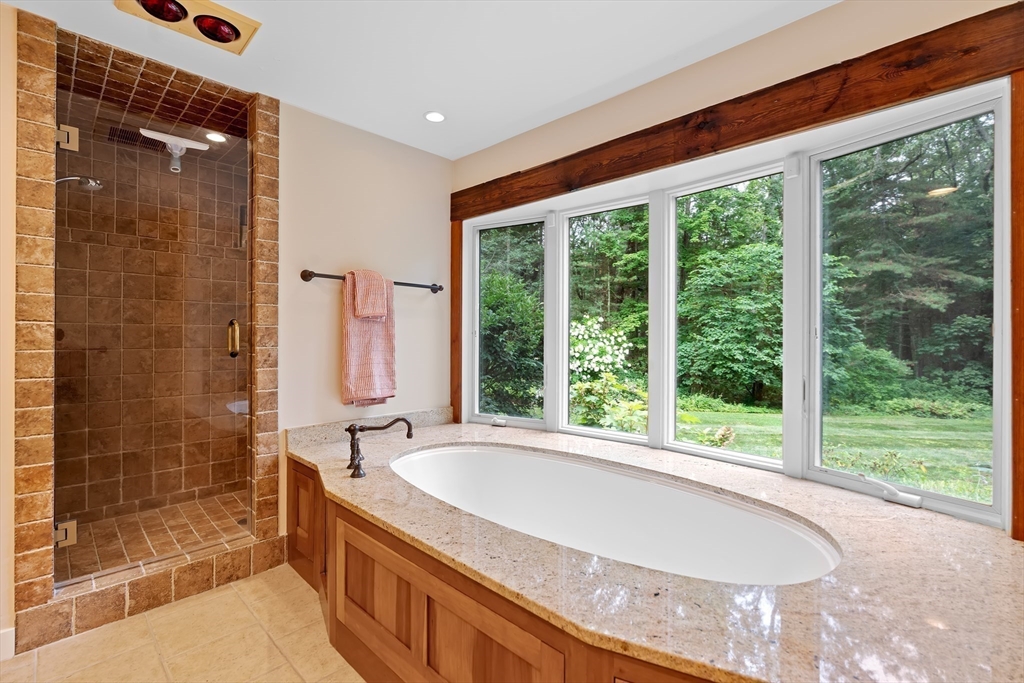 50 3 Ponds Road Wayland, MA 01778 - Photo 21 of 32 a bathroom with a granite countertop sink and a large mirror