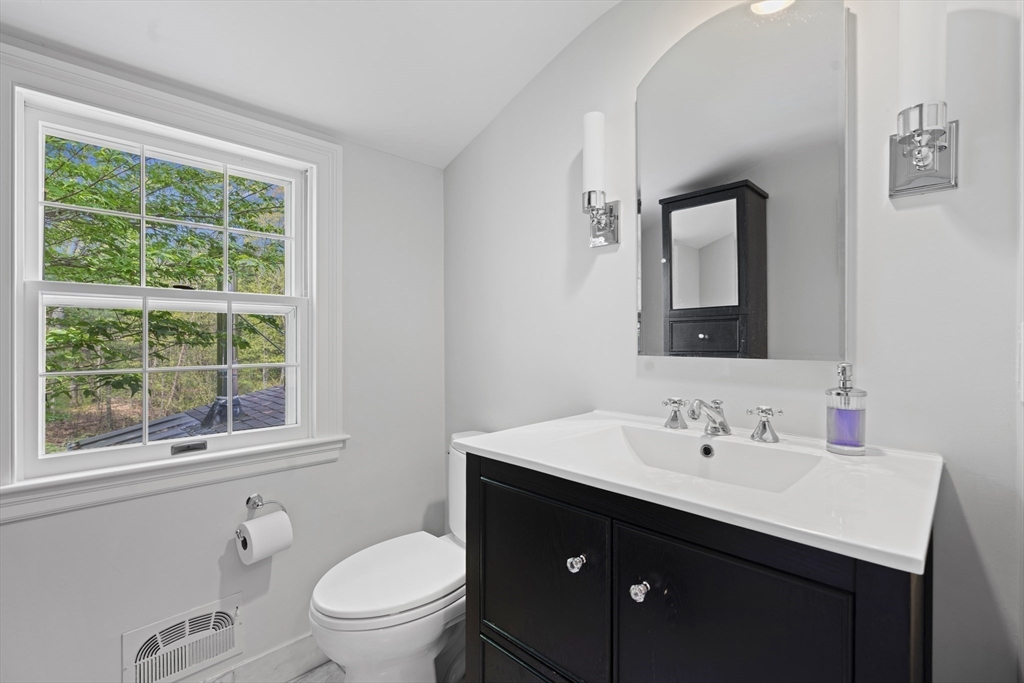 50 3 Ponds Road Wayland, MA 01778 - Photo 23 of 32 a bathroom with a sink a toilet and a window