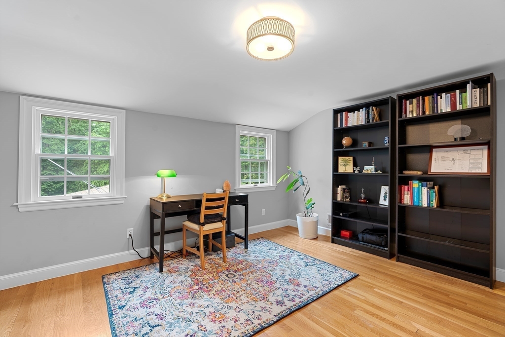 50 3 Ponds Road Wayland, MA 01778 - Photo 25 of 32 a view of a workspace with furniture and a bookshelf