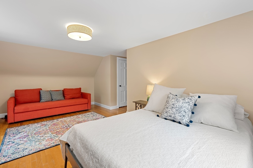 50 3 Ponds Road Wayland, MA 01778 - Photo 26 of 32 a bedroom with a bed and a couch
