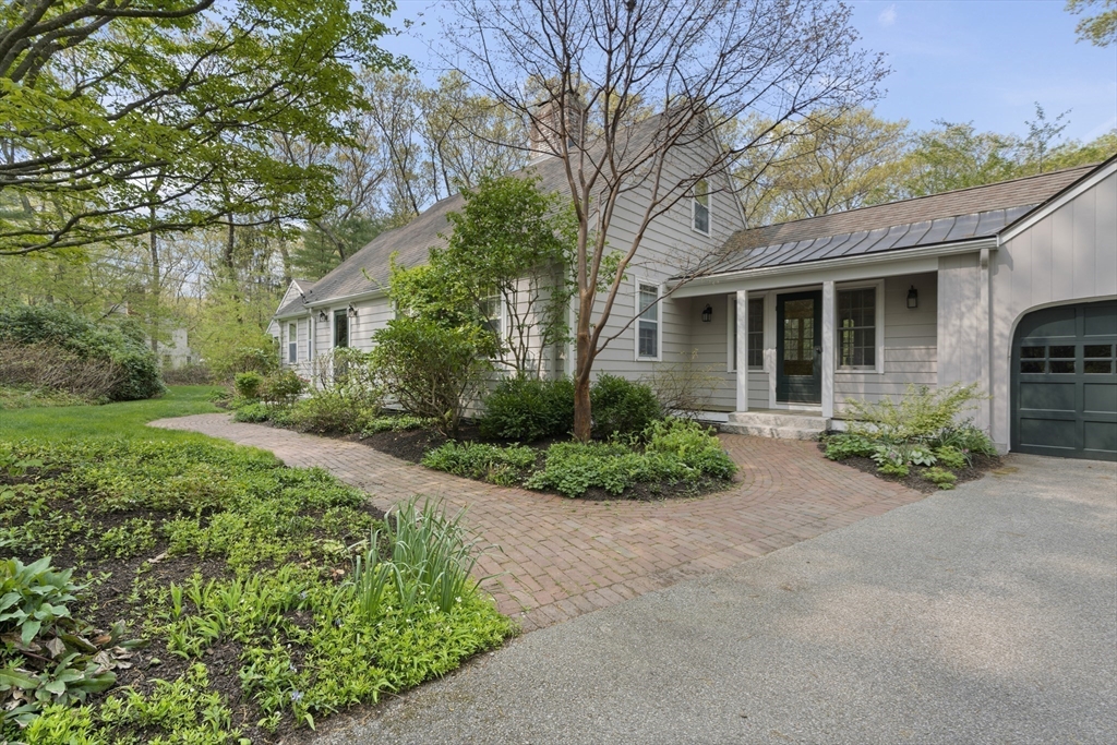 50 3 Ponds Road Wayland, MA 01778 - Photo 4 of 32 a front view of a house with garden and plants