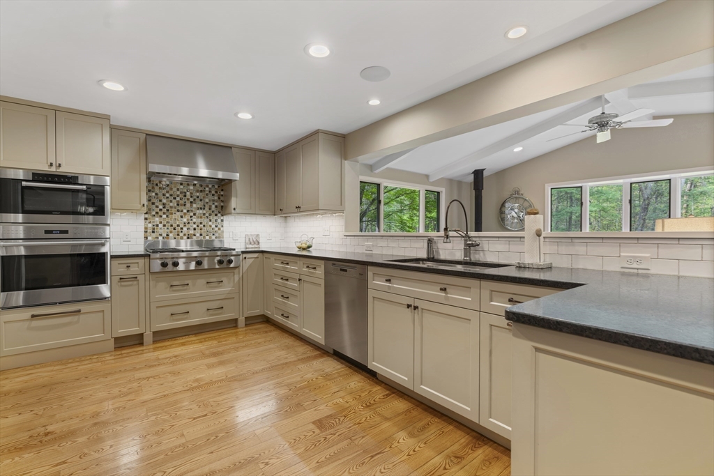 50 3 Ponds Road Wayland, MA 01778 - Photo 5 of 32 a kitchen with stainless steel appliances granite countertop a sink and cabinets