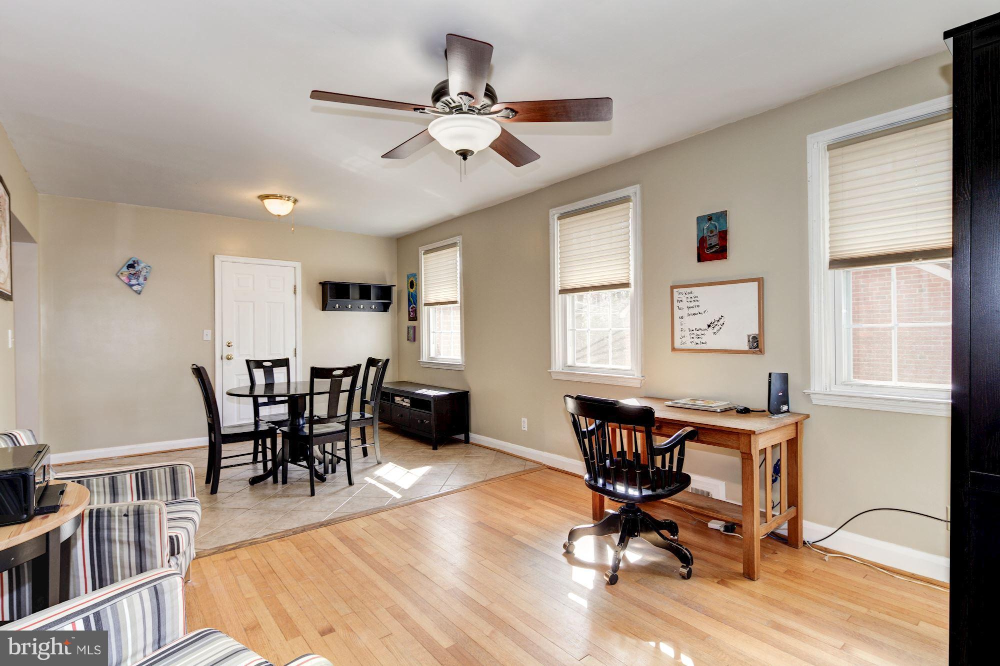 6722 Sherwood Road Baltimore, MD 21239 - Photo 15 of 30 a view of a dining room with furniture window and wooden floor