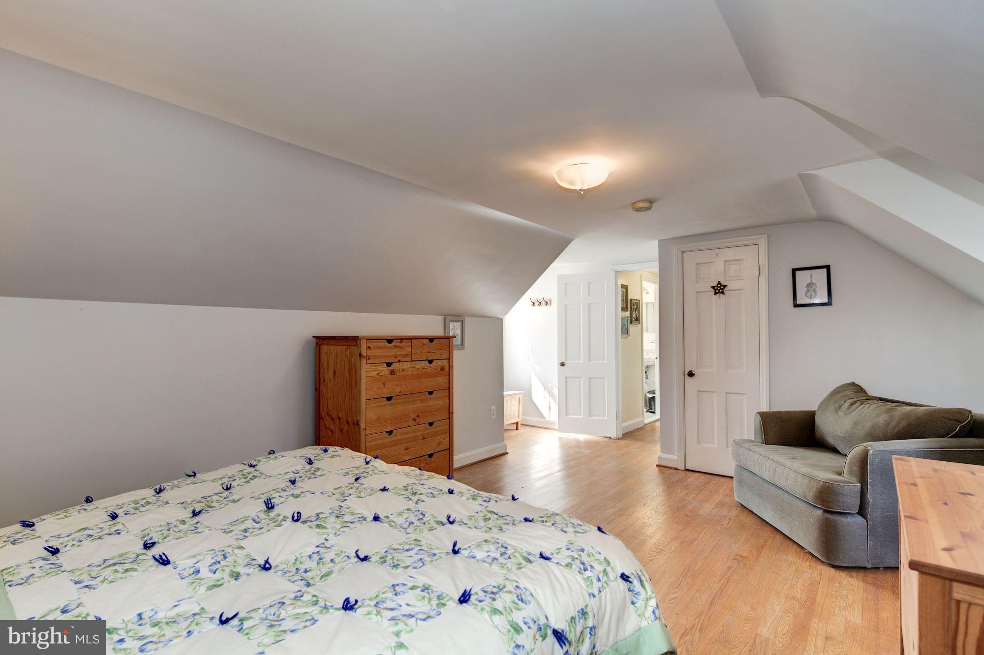 6722 Sherwood Road Baltimore, MD 21239 - Photo 20 of 30 a bedroom with a bed and wooden floor