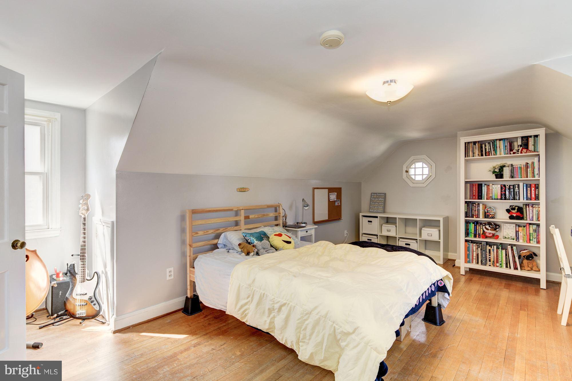 6722 Sherwood Road Baltimore, MD 21239 - Photo 23 of 30 a bed room with a bed and a book shelf