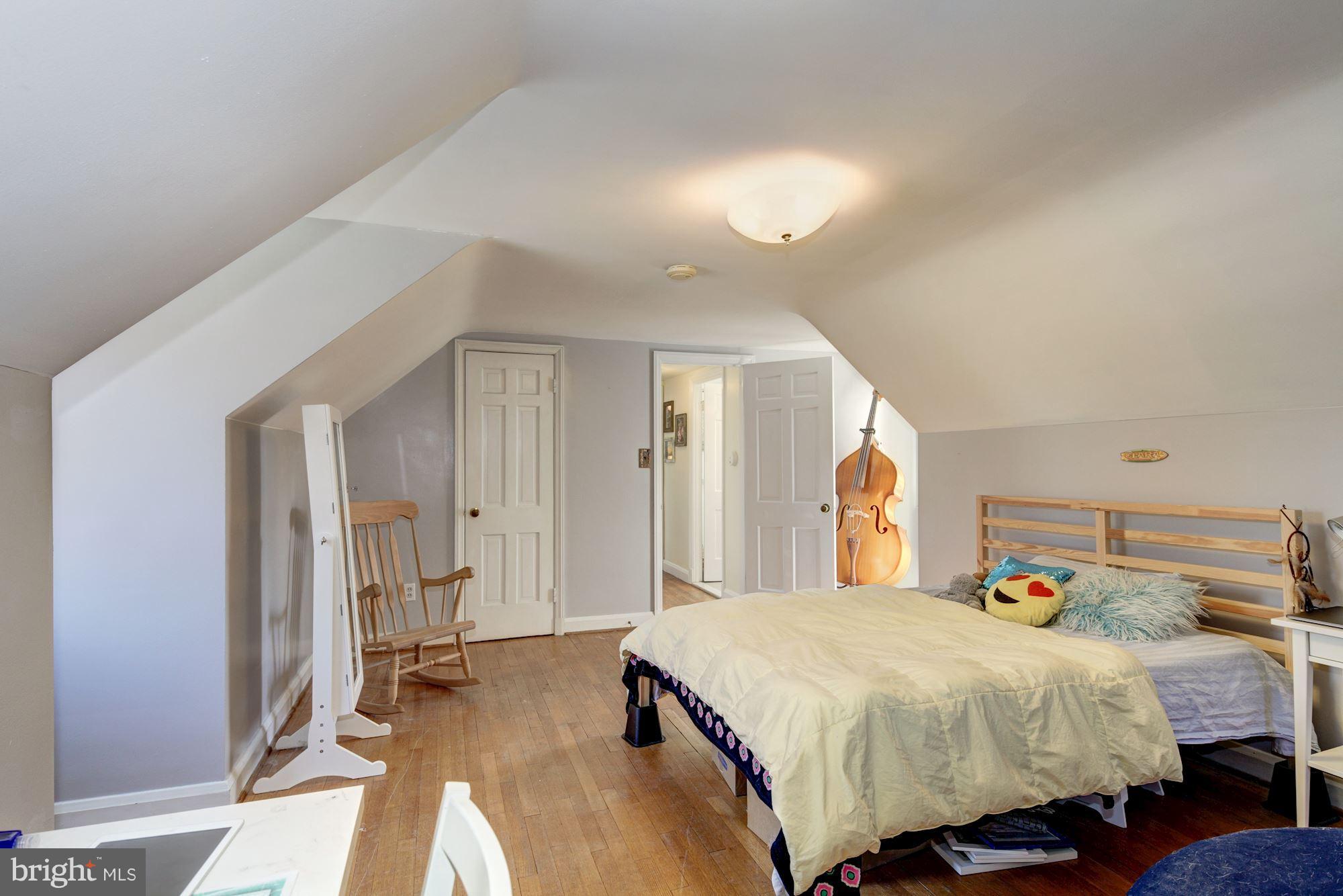 6722 Sherwood Road Baltimore, MD 21239 - Photo 24 of 30 a bedroom with a bed and a mirror