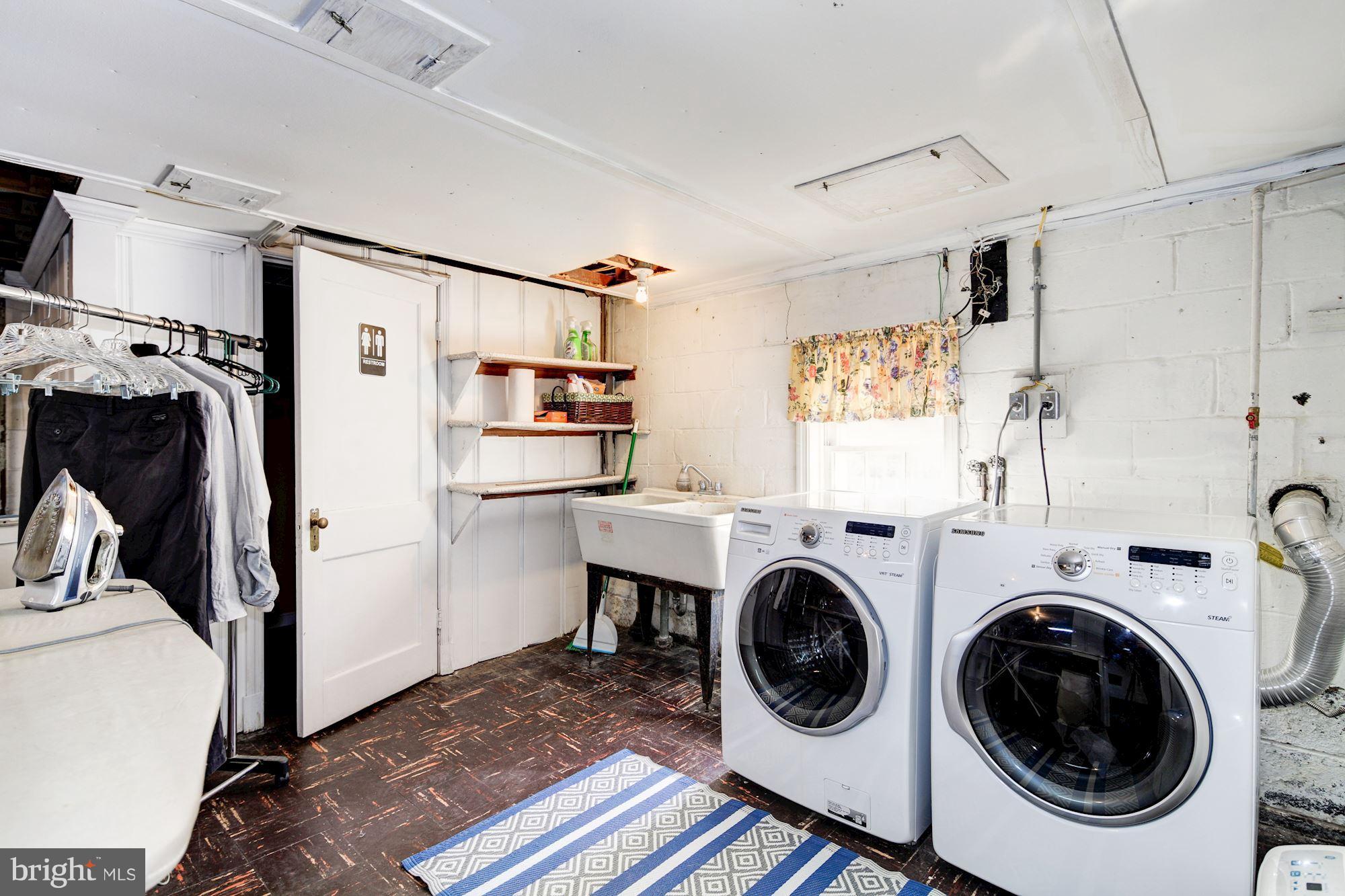 6722 Sherwood Road Baltimore, MD 21239 - Photo 27 of 30 a view of a storage & utility room with sink dryer and washer