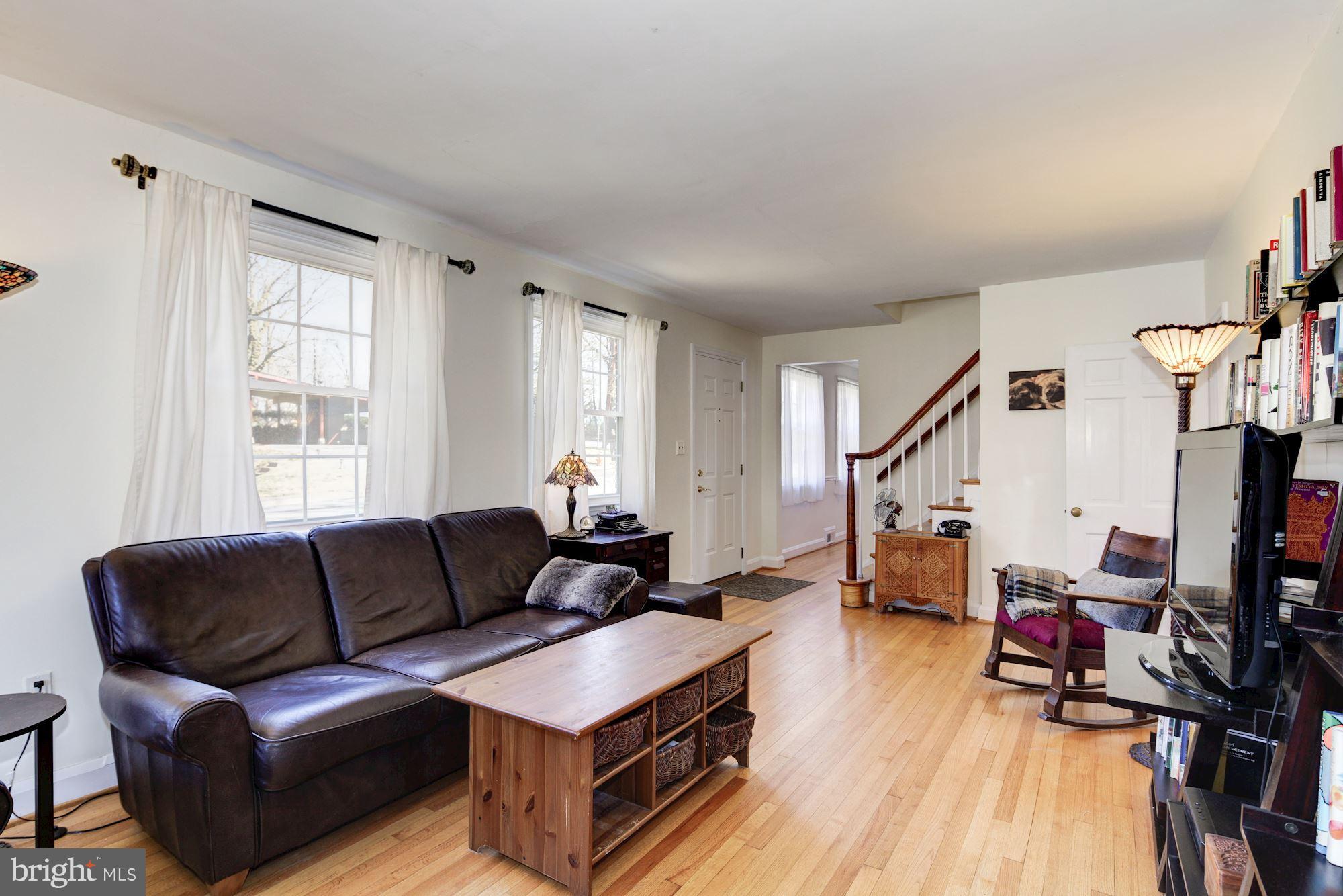 6722 Sherwood Road Baltimore, MD 21239 - Photo 5 of 30 a living room with furniture and a wooden floor