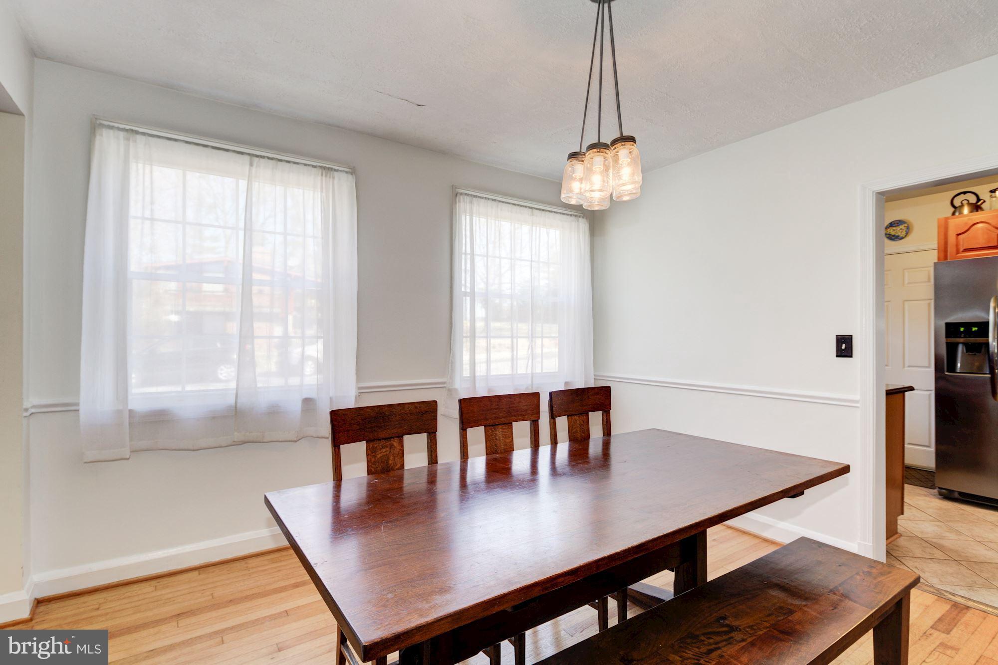 6722 Sherwood Road Baltimore, MD 21239 - Photo 6 of 30 a view of a dining room with furniture window and wooden floor