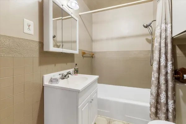 an empty room with wooden floor closet and windows