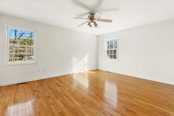 a kitchen with stainless steel appliances granite countertop a refrigerator a sink dishwasher a stove and a dining table with wooden floor