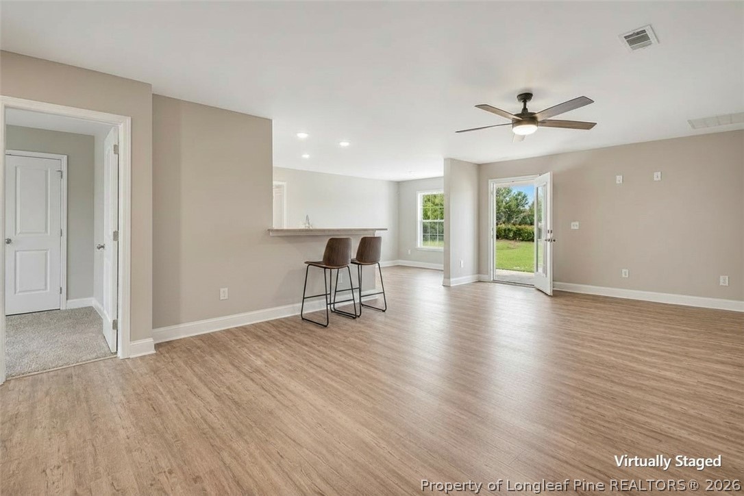 756 Jordan Road Autryville, NC 28318 - Photo 19 of 34 a view of an empty room with window wooden floor and a ceiling fan