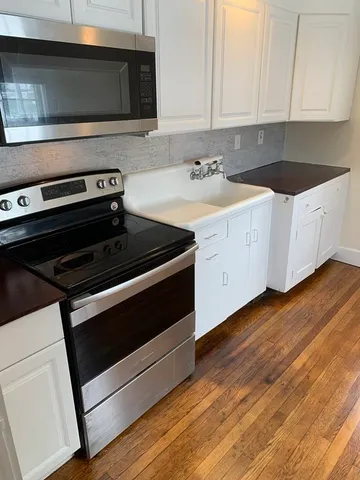 a kitchen with appliances and cabinets